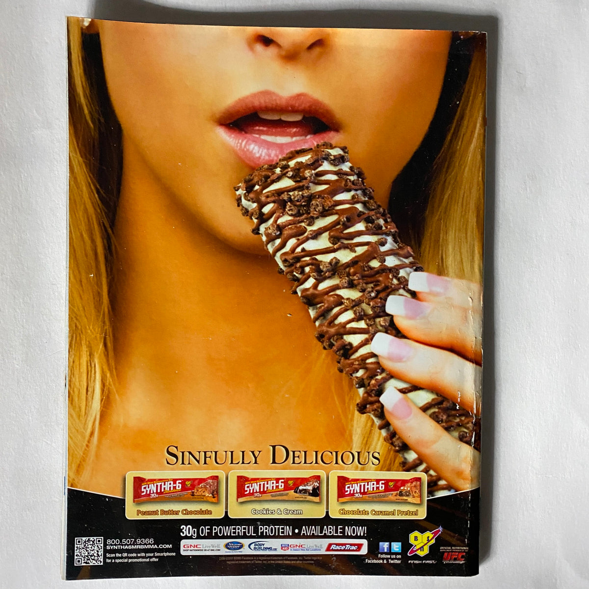 Back cover of the UFC Magazine April/May 2011, Issue No. 10 featuring an advertisement for protein bars with a model holding a snack, promoting a healthy lifestyle for MMA enthusiasts.