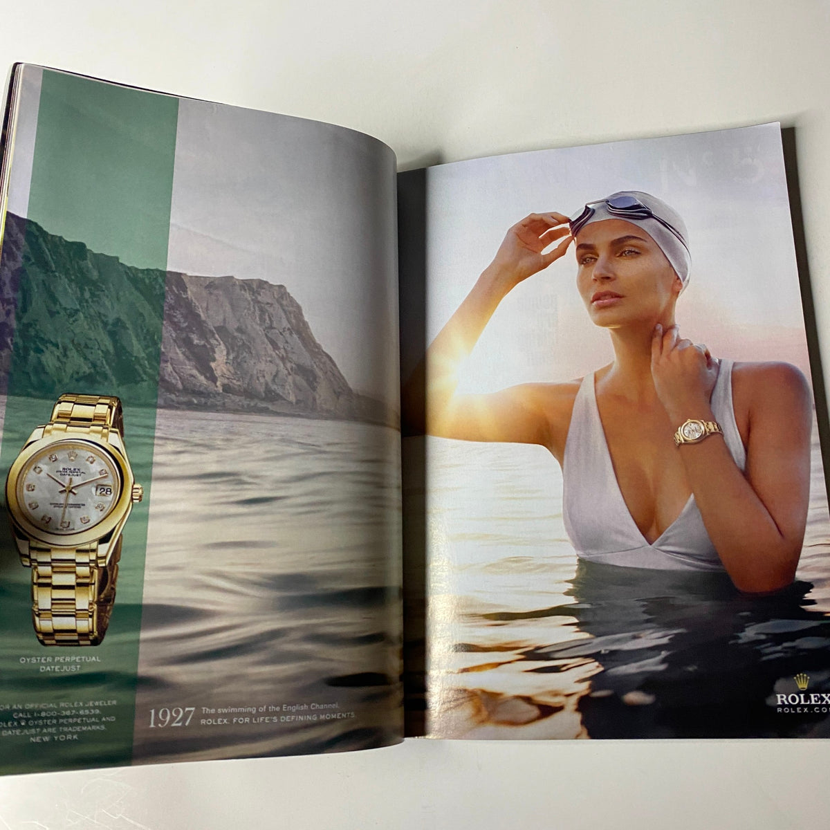 Vogue Magazine November 2009 featuring a Rolex advertisement with a model in a swimming pool, highlighting luxury timepieces. This magazine edition includes iconic personalities like Nicole Kidman and Marion Cotillard on the cover.