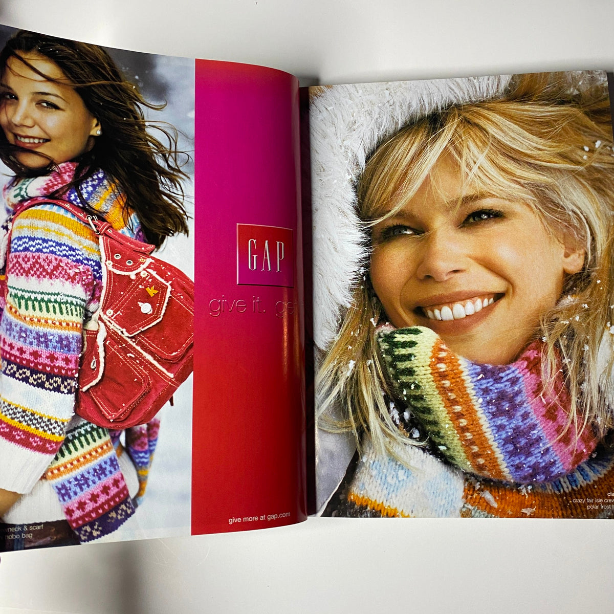 Vogue Magazine December 2003 featuring colorful Gap fashion with a model in a vibrant sweater and smiling outdoors with snow in the background.