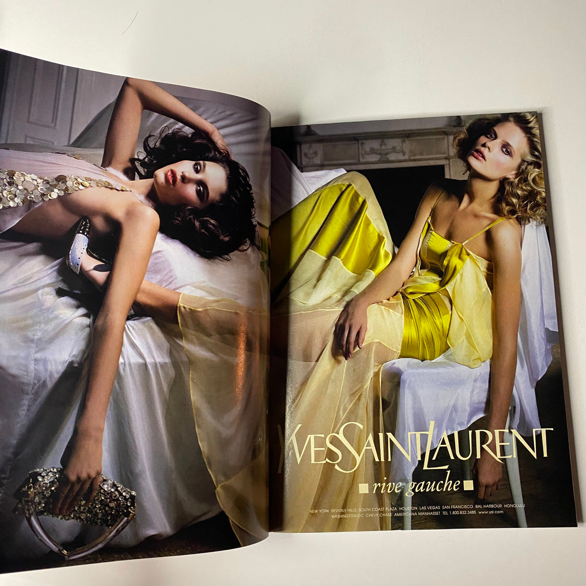 A fashion spread in Vogue Magazine February 2004 showcasing Yves Saint Laurent designs, emphasizing elegance and high fashion aesthetics.