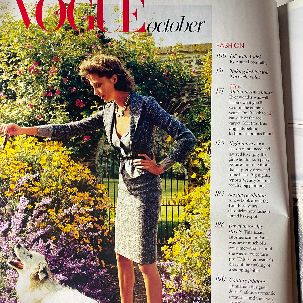 Inside page of Vogue Magazine October 2004 with a fashion editorial, featuring a model in a stylish outfit among blooming flowers, reflecting the magazine's seasonal fashion insights.