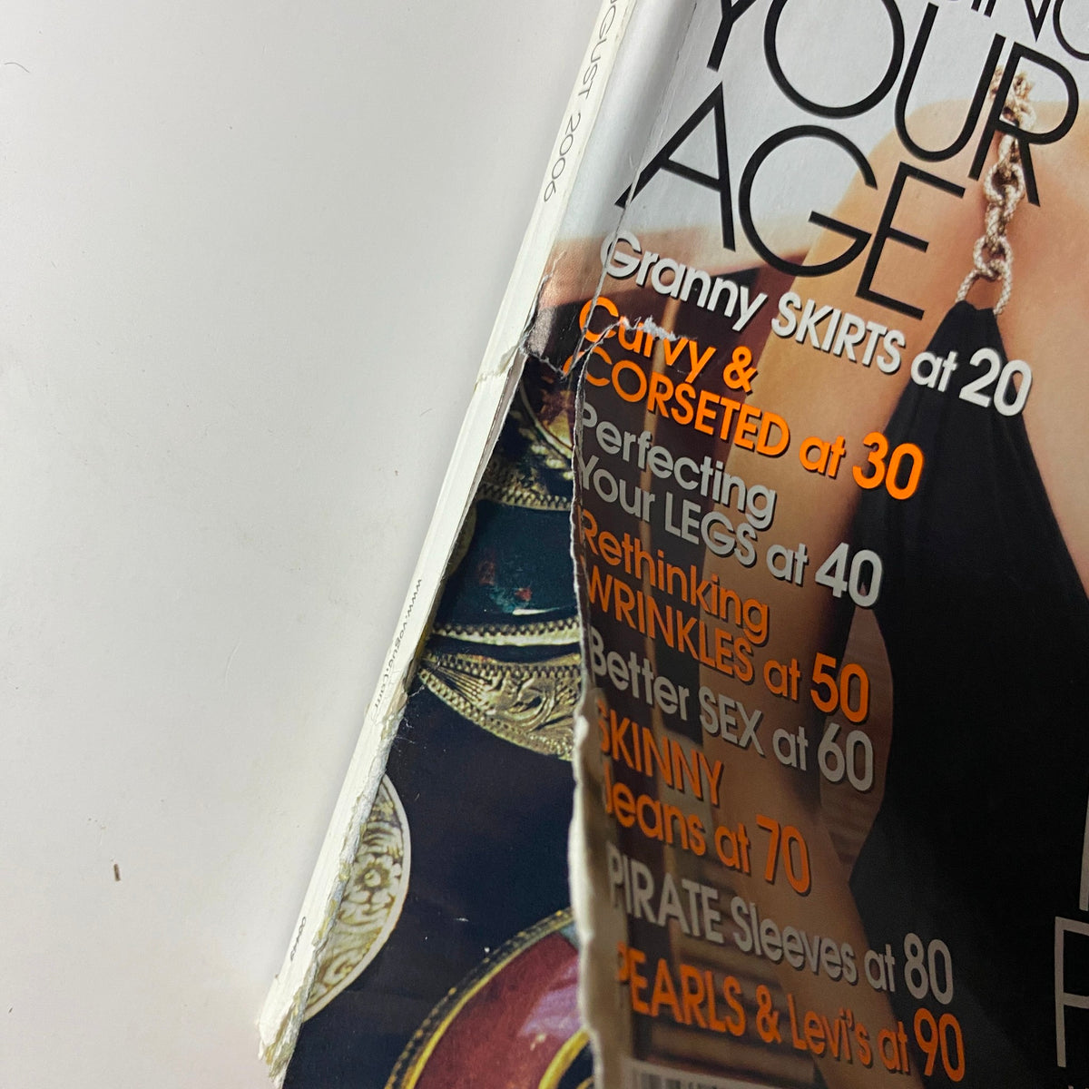 Close-up detail of the Vogue Magazine August 2006 cover highlighting styling tips like 'Curvy Skirts at 20' and 'Perfecting Your Legs at 40'.