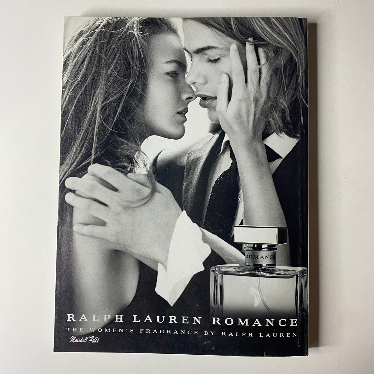 Ralph Lauren Romance fragrance advertisement in Vogue Magazine April 2006 featuring a romantic black and white image of a couple, associated with the Jennifer Aniston cover edition.