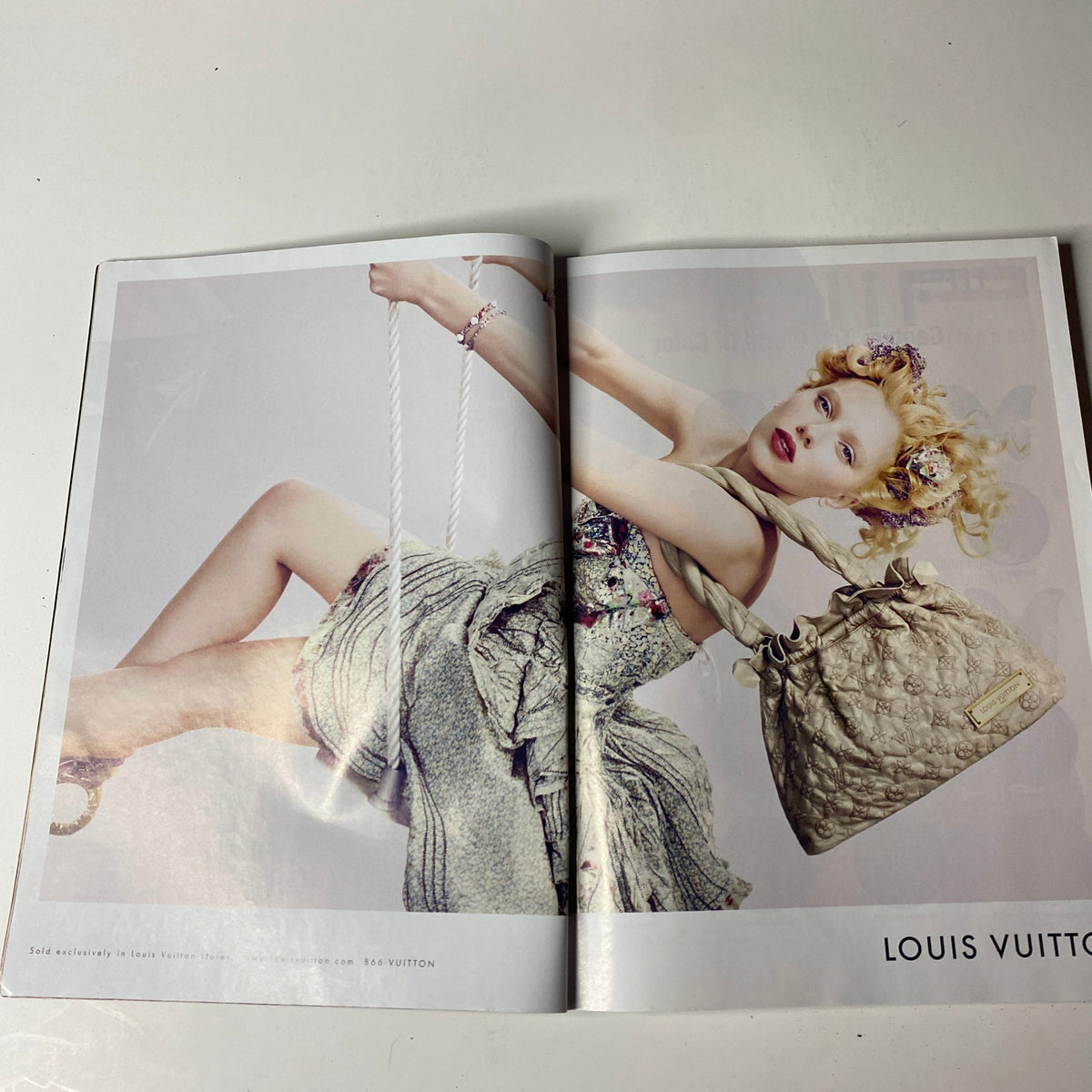 Double-page spread from Vogue Magazine June 2007 featuring a Louis Vuitton advertisement with a model showcasing fashion designs.