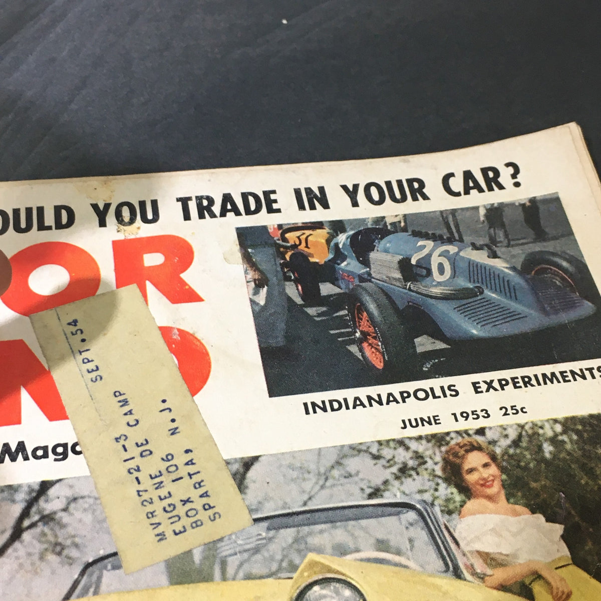 Part of the June 1953 Motor Trend Magazine cover displaying a blue vintage car and the text 'Indianapolis Experiments', related to the VTG Motor Trend Magazine June 1953.