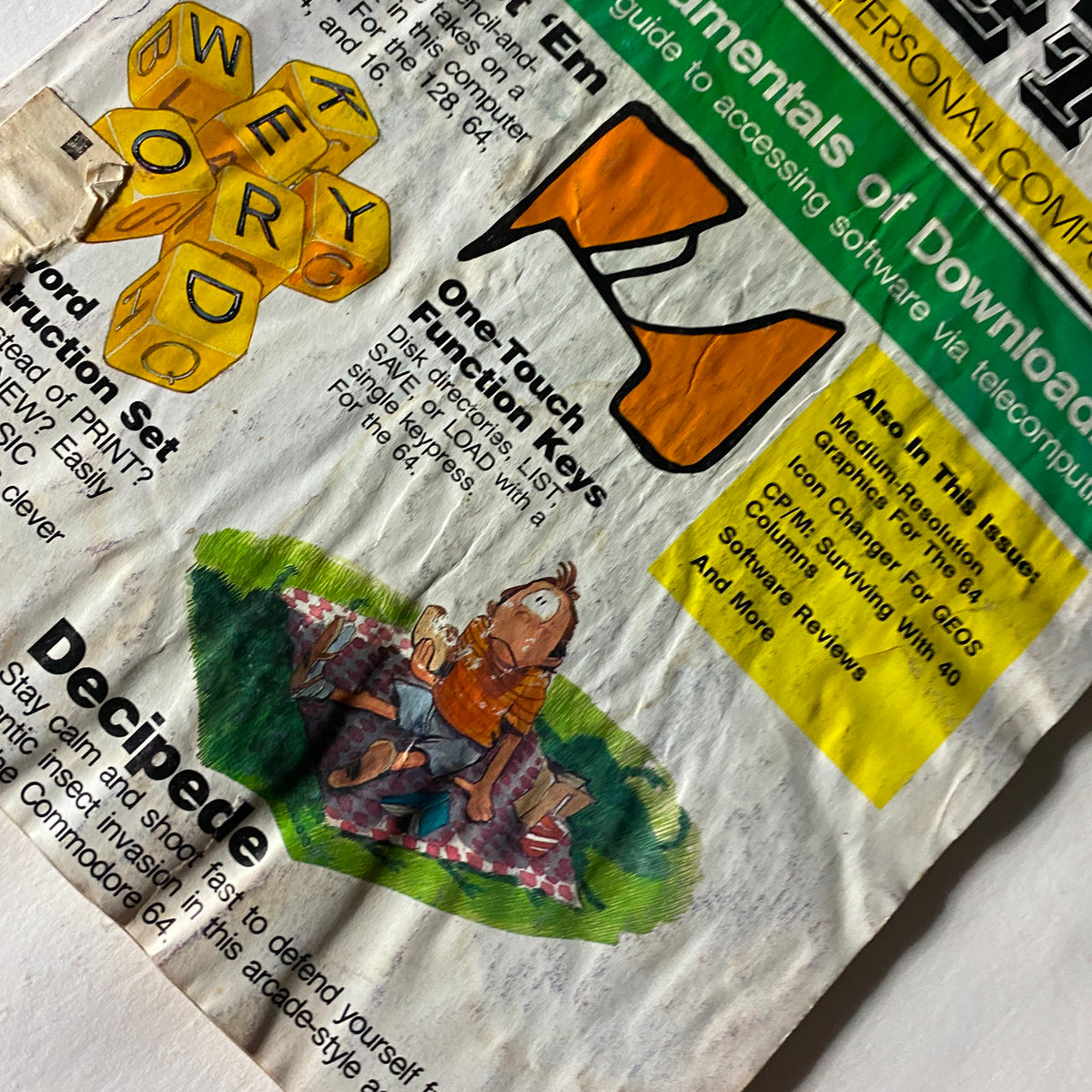 Close-up of Compute's Gazette Magazine January 1987 cover detailing sections like 'One-Touch Function Keys' and 'Decipede' with vintage illustrations.