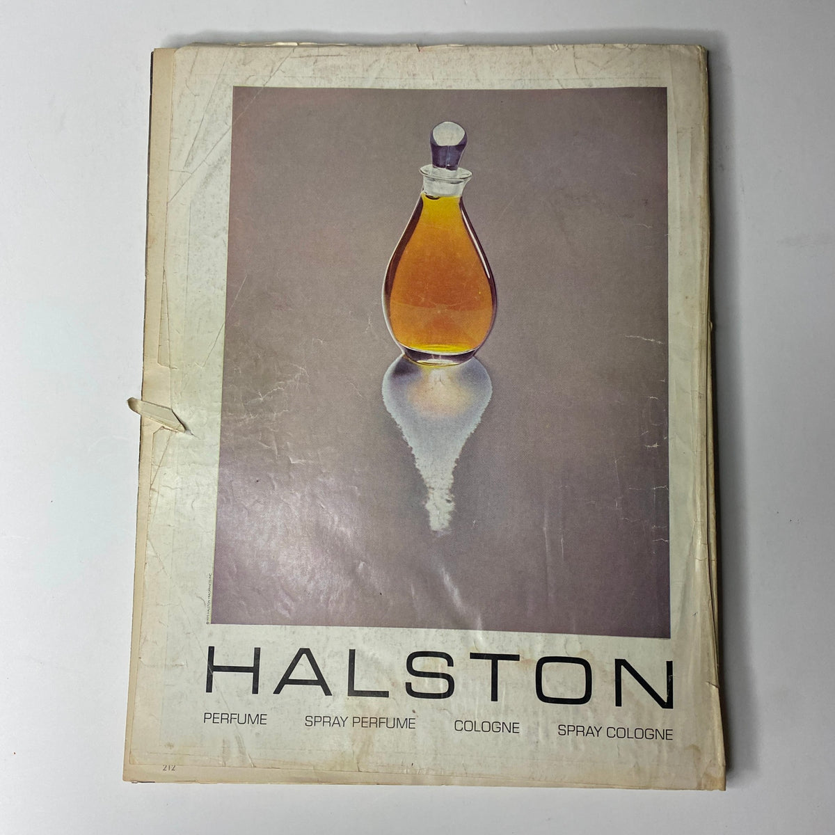 Back cover of Vogue Magazine May 1976 displaying a stylish Halston perfume advertisement, emphasizing the elegance of 1970s fragrance design.