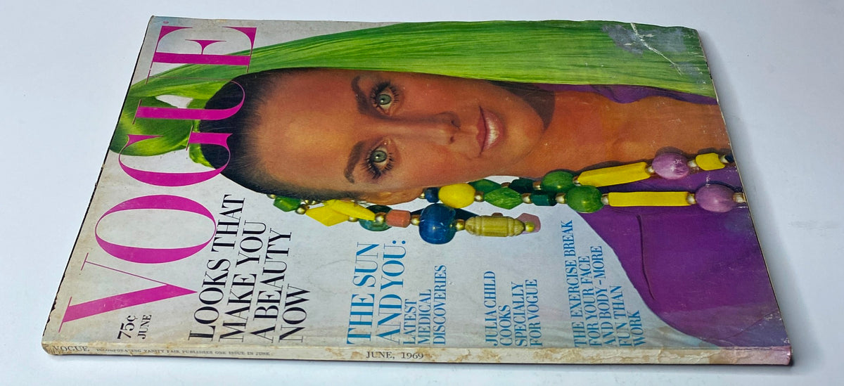 Vogue Magazine June 1969 depicting the same model with vibrant green hair and bold jewelry, emphasizing beauty trends of the late 1960s.