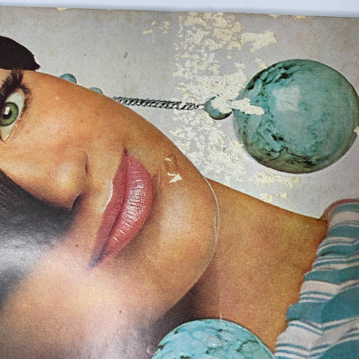 Close-up of the cover of Vogue Magazine January 15, 1966, highlighting Marisa Berenson's striking features and turquoise earrings, along with visible wear on the magazine edge.