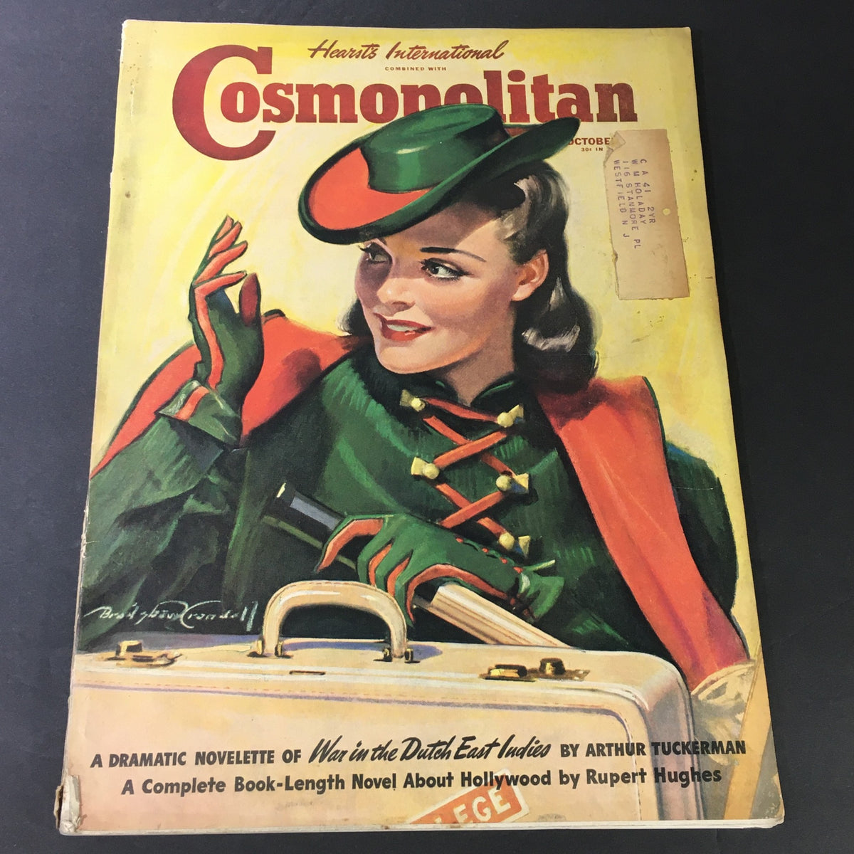 VTG Cosmopolitan Magazine #65 October 1940 cover featuring a beautiful woman in vintage fashion by Bradford Crandell with a suitcase.