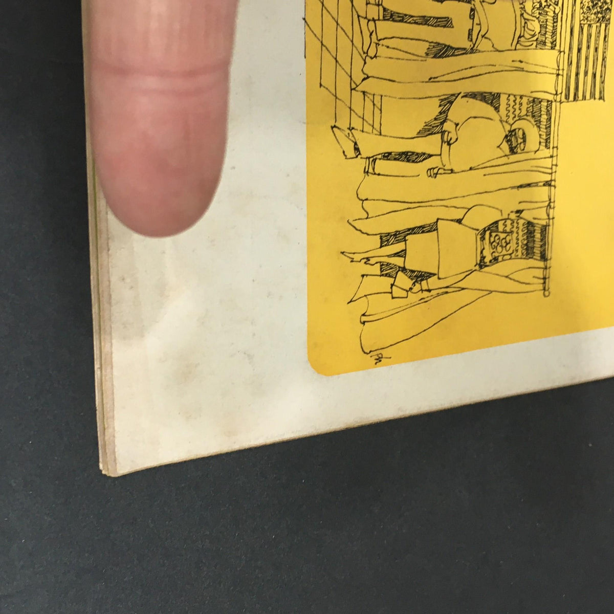 View of the spine and back cover of the vintage U.S. News & World Report magazine, showcasing age-related wear and a colorful yellow promotional sticker.