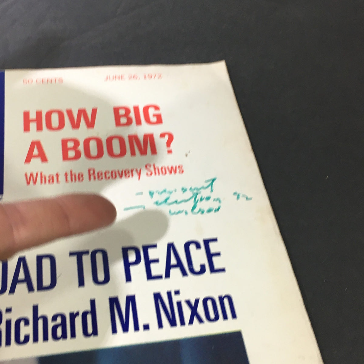 Close-up view of the vintage U.S. News & World Report magazine cover from June 26, 1972, with President Nixon's article 'The Real Road to Peace'. The image shows a hand pointing at the title, which is marked with green ink.