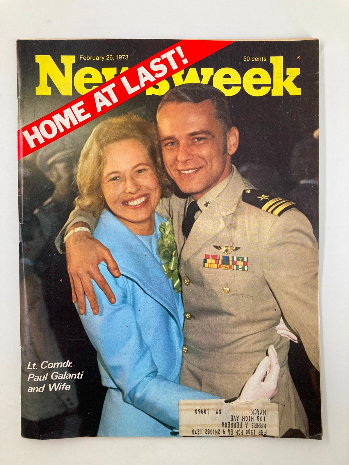 Cover of VTG Newsweek Magazine from February 26, 1973, featuring Lt. Cmdr. Paul Galanti and his wife, celebrating their reunion with the bold headline 'HOME AT LAST!'. This vintage magazine captures a significant moment in history, showcasing the personal stories of military families during the Vietnam War era.