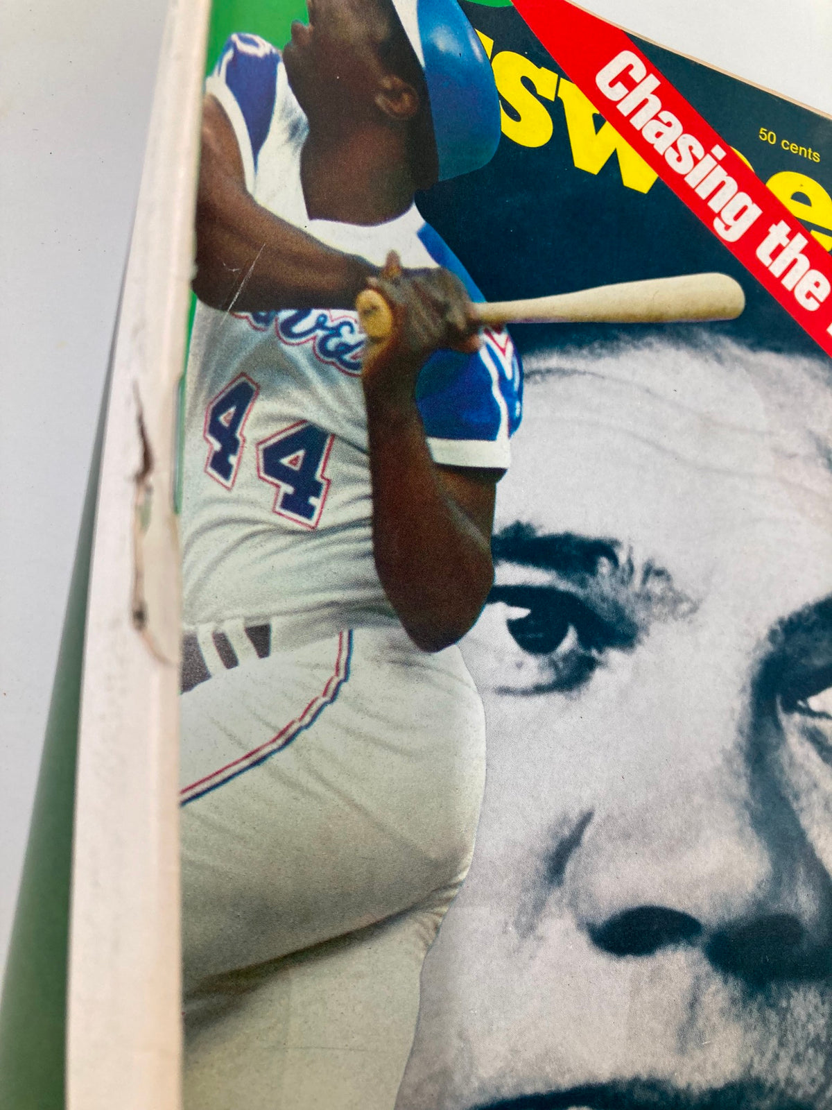 Close-up of the vintage August 13, 1973 Newsweek magazine cover showing Hank Aaron swinging a bat, highlighting the 'Chasing the Babe' headline and Babe Ruth's face in the background.