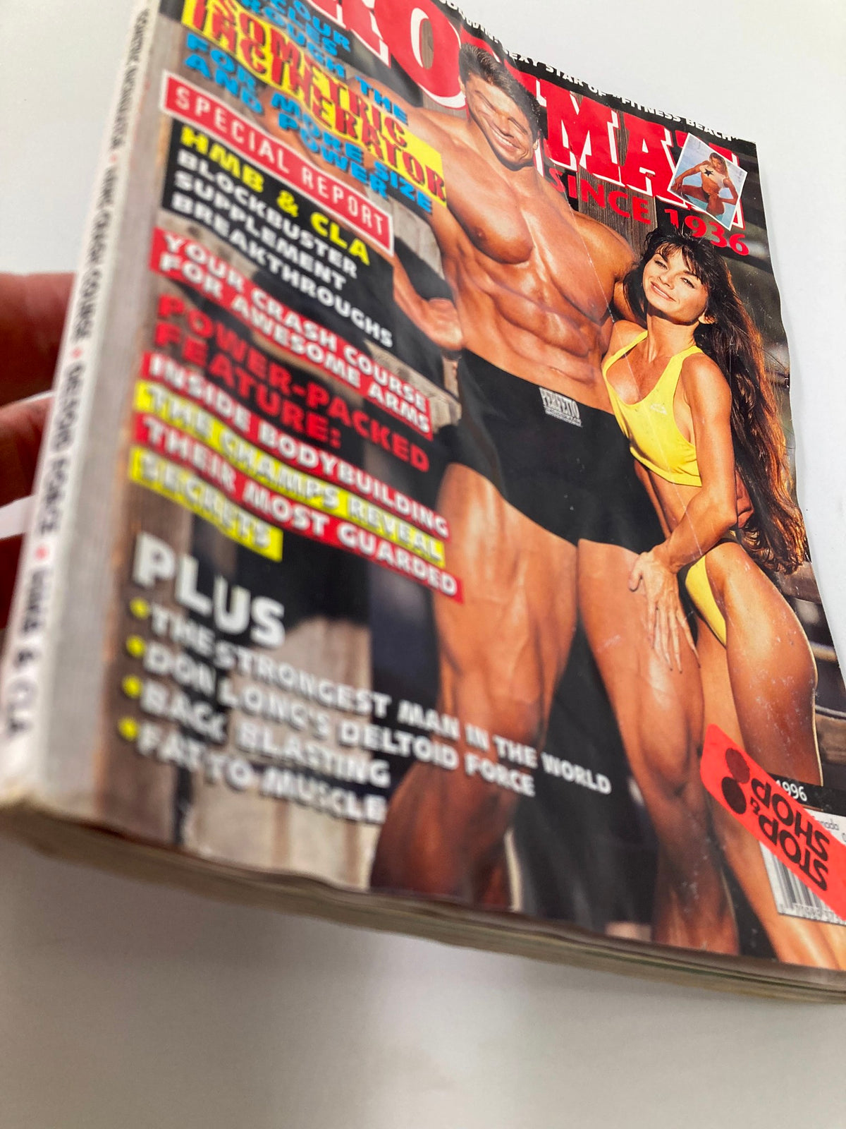 Side view of Ironman Magazine June 1996 displaying the worn edges and condition of the magazine cover with a 'Stop Shop' sticker.