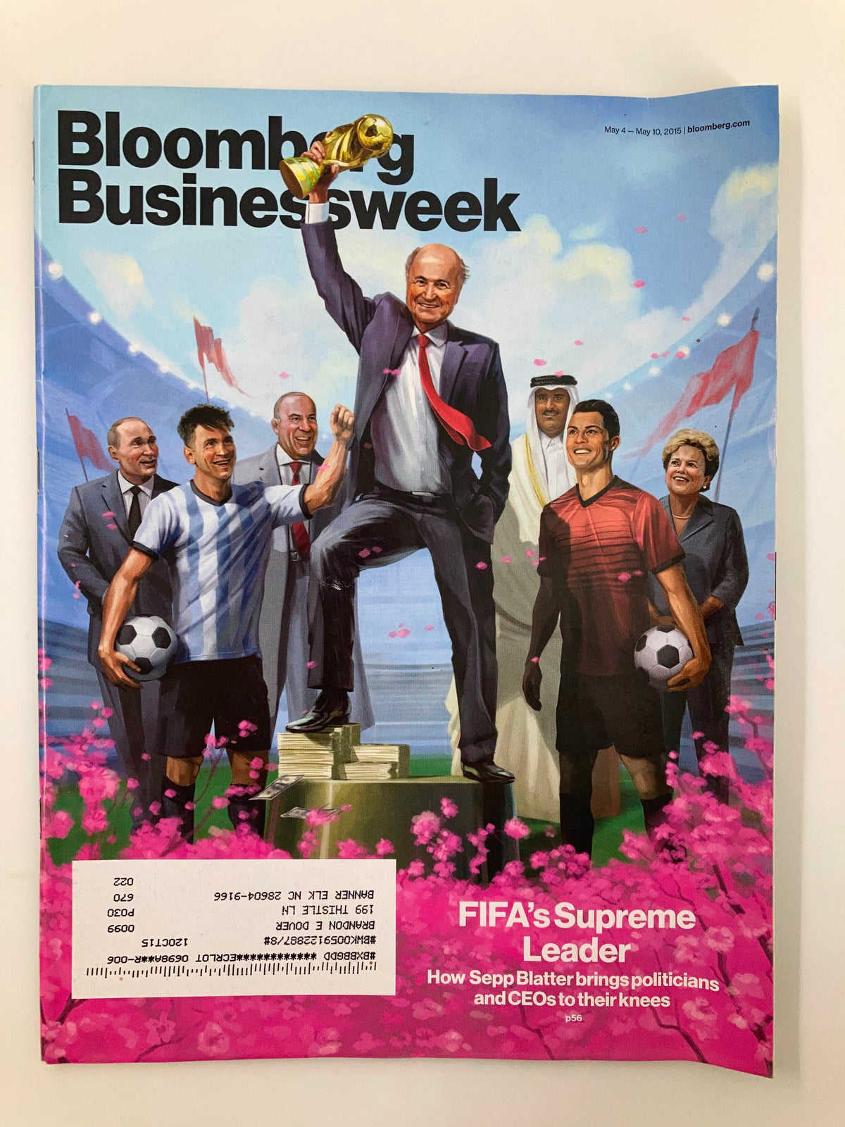 Bloomberg Businessweek Magazine May 4 2015 cover featuring Sepp Blatter holding the FIFA World Cup trophy surrounded by soccer players and dignitaries, illustrating the intersection of politics and soccer.