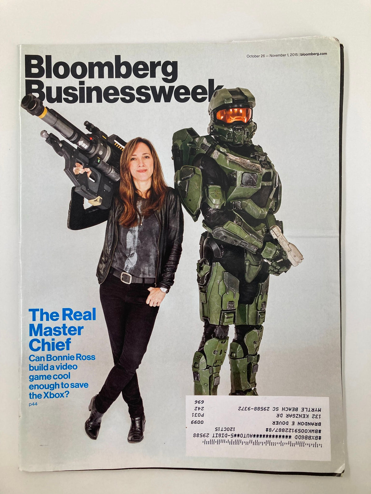Bloomberg Businessweek magazine cover from October 26, 2015, featuring a woman with a futuristic weapon and a life-sized robot character, titled 'Can Bonnie Ross Save The Xbox?'. This cover highlights Bonnie Ross's role in the gaming industry during a pivotal time for Xbox.