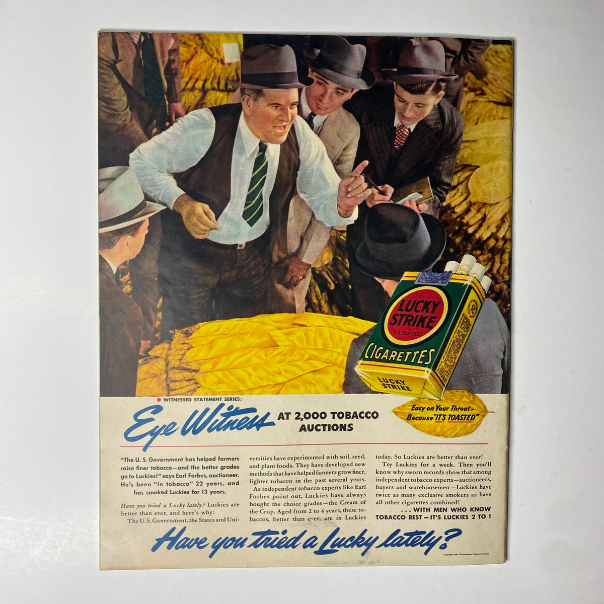Look Magazine September 12, 1939 advertisement for Lucky Strike cigarettes, showcasing men at tobacco auctions with a focus on the product and its promotion.