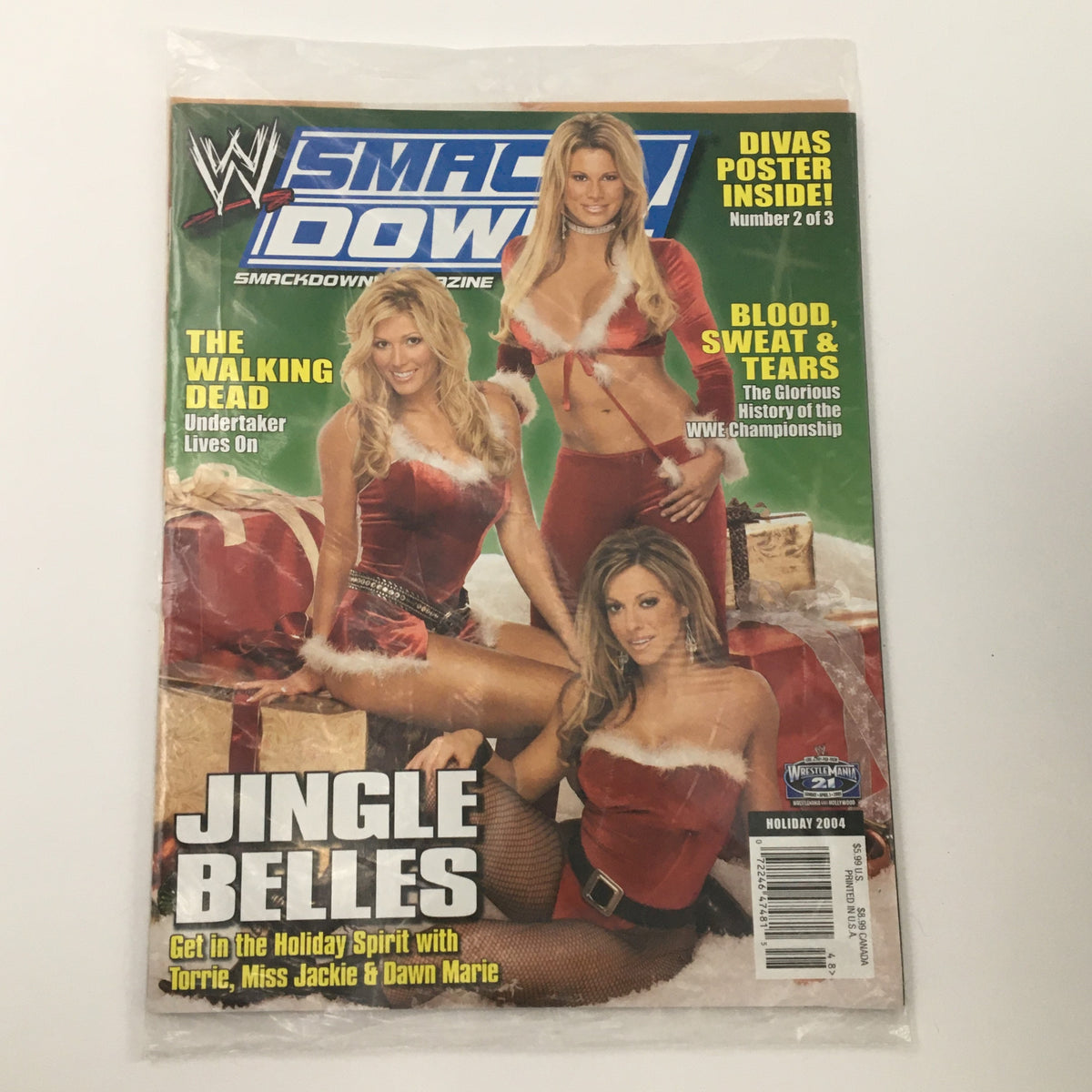 WWE Smack Down Magazine Holiday 2004 featuring Torrie, Miss Jackie, and Dawn Marie on cover. The magazine highlights wrestling divas with the headline 'Jingle Belles' and includes a poster.