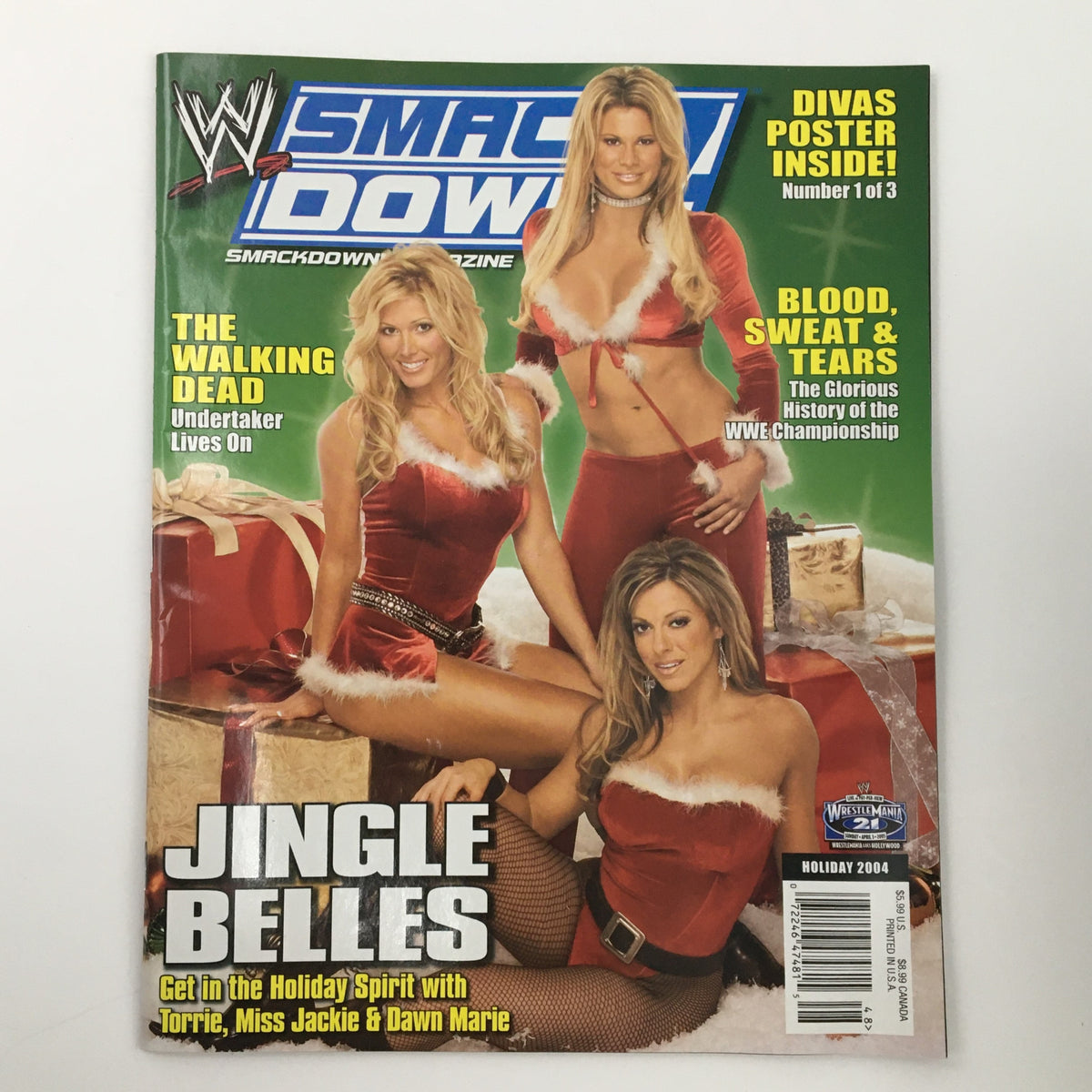 WWE Smack Down Holiday 2004 magazine cover featuring Torrie, Miss Jackie, and Dawn Marie in festive outfits. Title reads 'Jingle Belles' with additional text highlighting a poster inside.