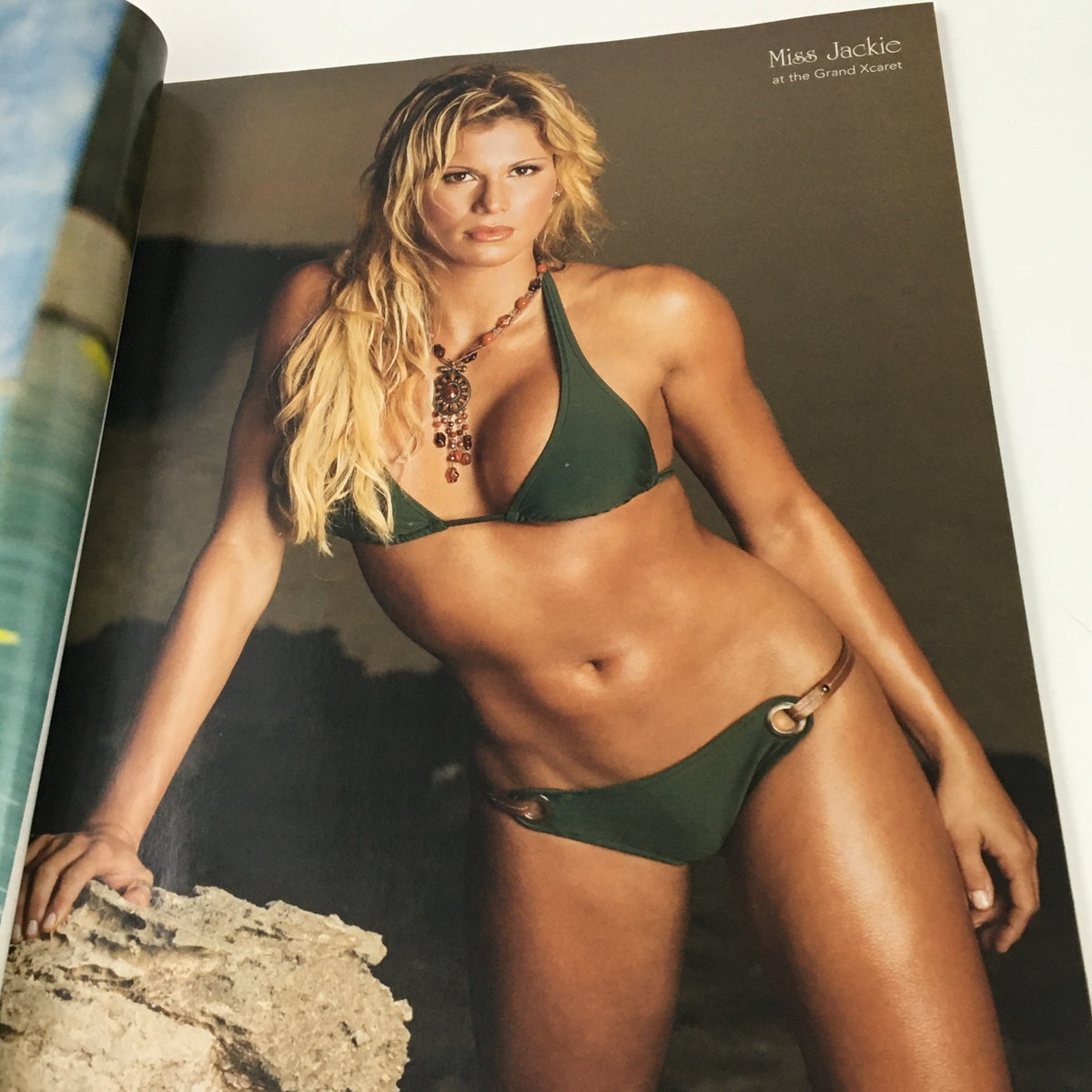 WWE Divas Magazine 2005 featuring Miss Jackie posing in a stunning green bikini at the Grand Xcaret, embodying the allure and glam of wrestling divas.