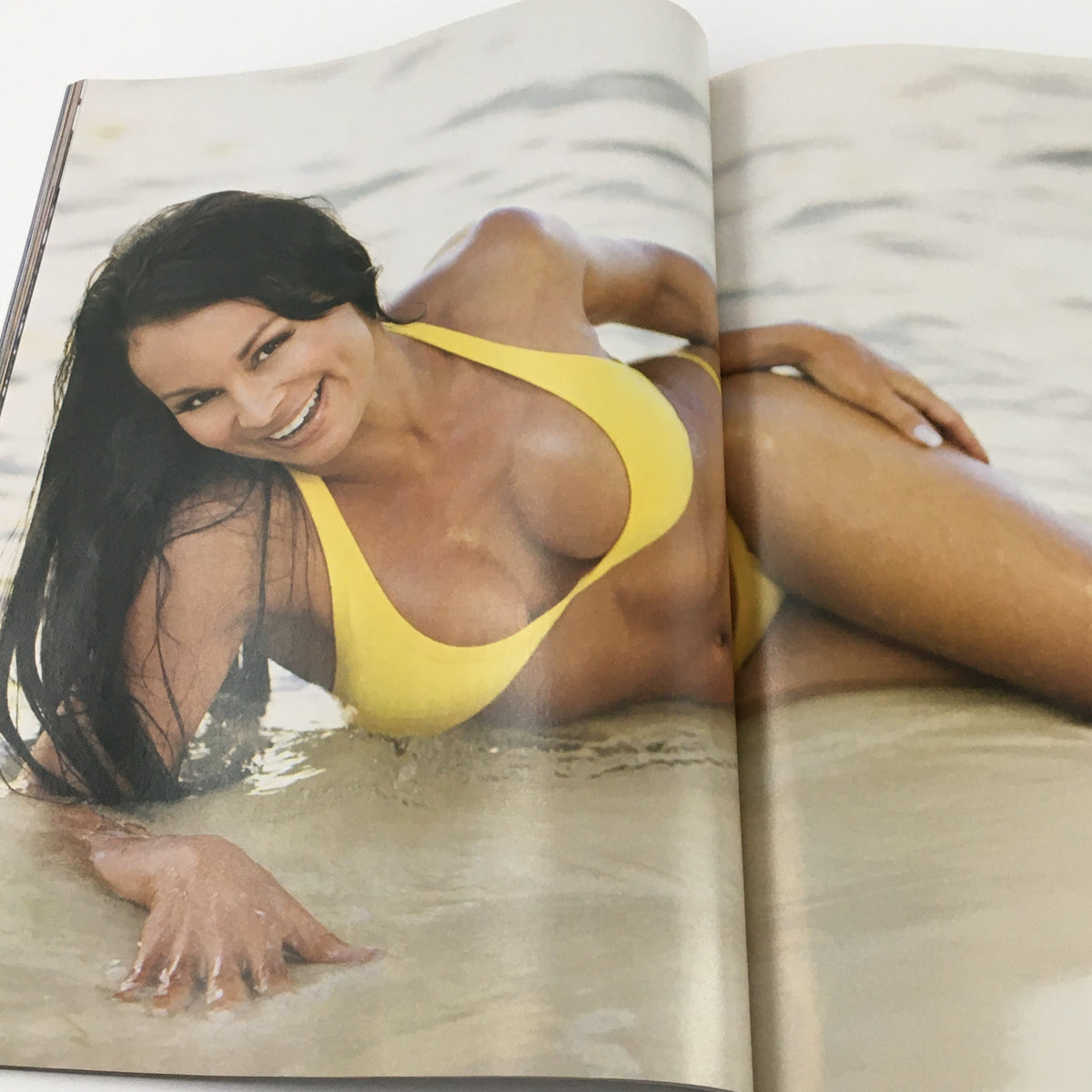 WWE Divas Magazine 2005 featuring a glamorous model in a yellow bikini, exuding confidence and beauty, showcasing the essence of Christy Hemme and Trish Stratus.