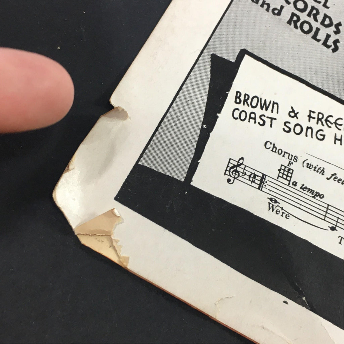 Close-up of the edge of vintage sheet music for 'I'm Thru Saying I'm Thru' highlighting minor wear and tear, a testament to its age and authenticity.