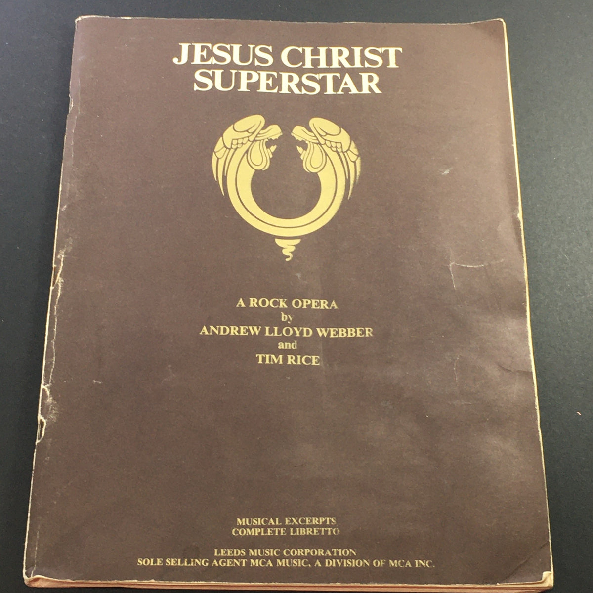 VTG 1970 Jesus Christ Superstar Music Book featuring the cover design with golden emblem, highlighting its status as a rock opera by Andrew Lloyd Webber and Tim Rice.