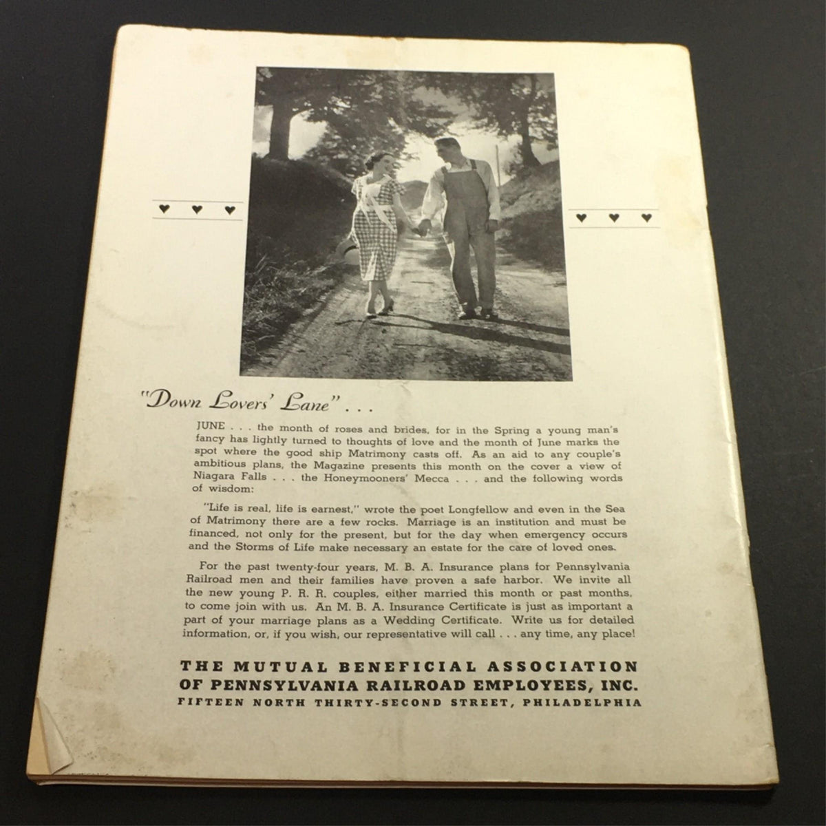 Back cover of the vintage magazine 'VTG The Mutual Magazine June 1938' featuring a romantic scene with a couple walking down a lane, embodying the nostalgic charm of the 1930s.
