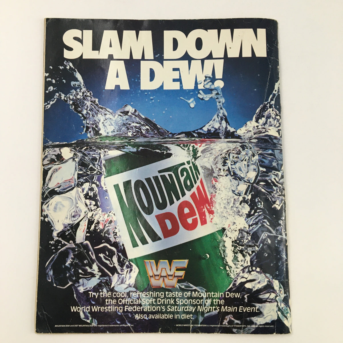 Cover of WWF Magazine July 1990 featuring a Mountain Dew advertisement with the phrase 'SLAM DOWN A DEW!' showcasing the vibrant colors and imagery of the popular soft drink, representing its partnership with the World Wrestling Federation.