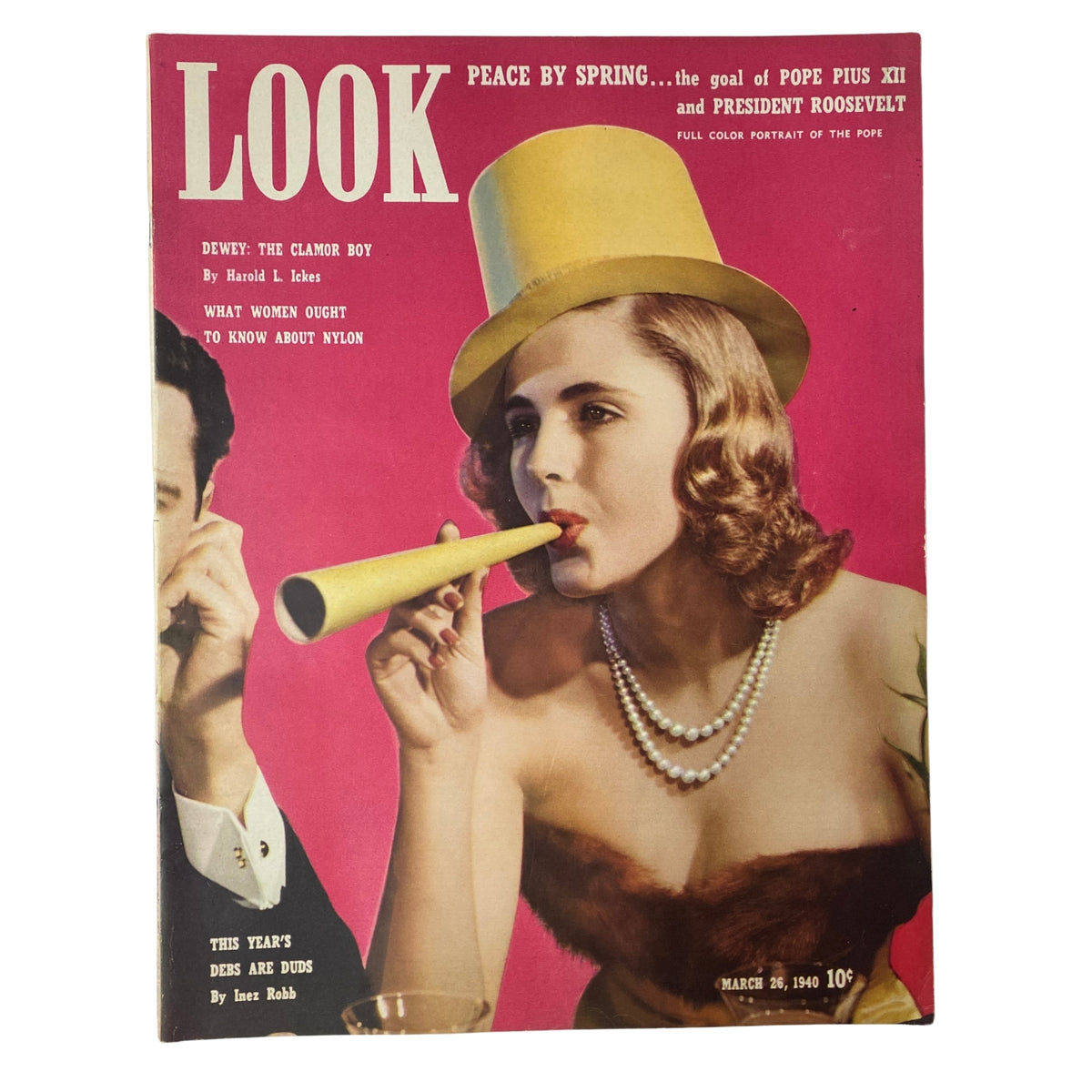 Cover of Look Magazine dated March 26, 1940, featuring bold colors and an image of a woman wearing a bright yellow hat, with the title 'This Year's Debs Are Duds' prominently displayed.