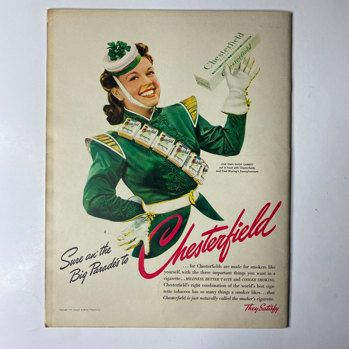 Advertisement from Look Magazine dated March 25, 1941, promoting Chesterfield cigarettes, featuring a smiling woman in a marching band uniform, inviting consumers to choose Chesterfield.