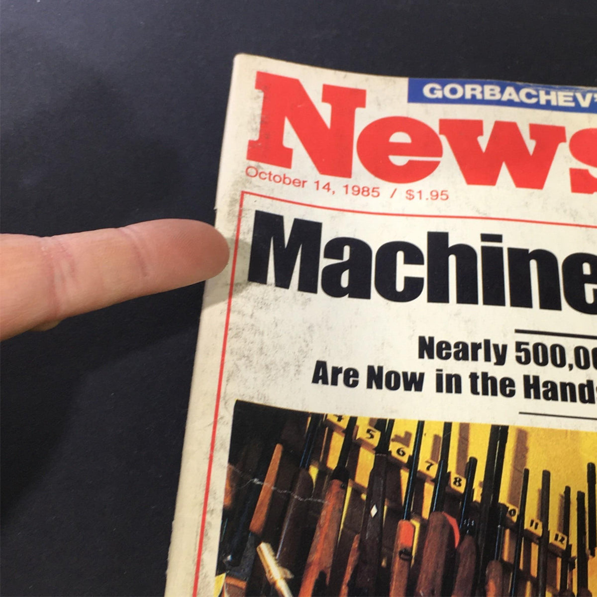 Close-up of the cover of Vintage Newsweek magazine from October 14, 1985, emphasizing the title 'Machine Gun U.S.A.' and details about the featured article on firearms.
