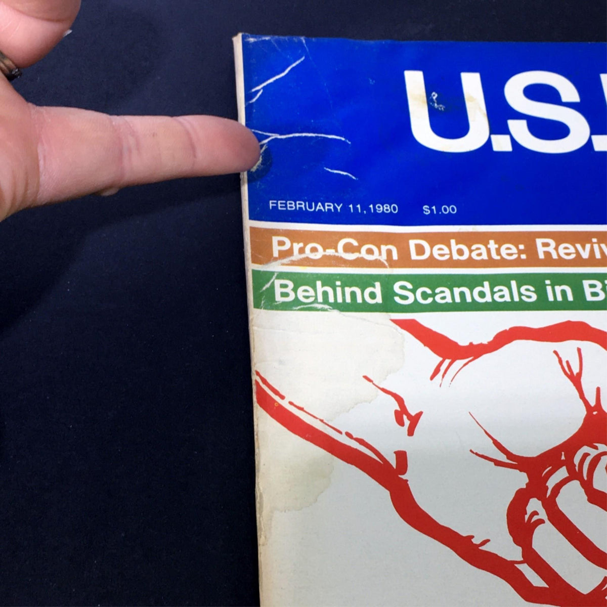 Close-up view of the top edge of the US News & World Report Magazine from February 11, 1980, showing details like the date and magazine title, along with visible wear on the cover.