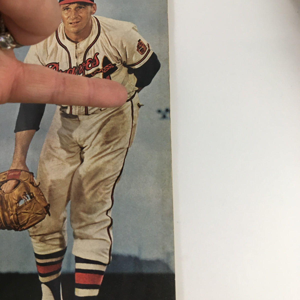 Close-up of Warren Spahn on the cover of Sport Magazine August 1961, illustrating his pitching stance and vintage baseball uniform with details from the magazine title.