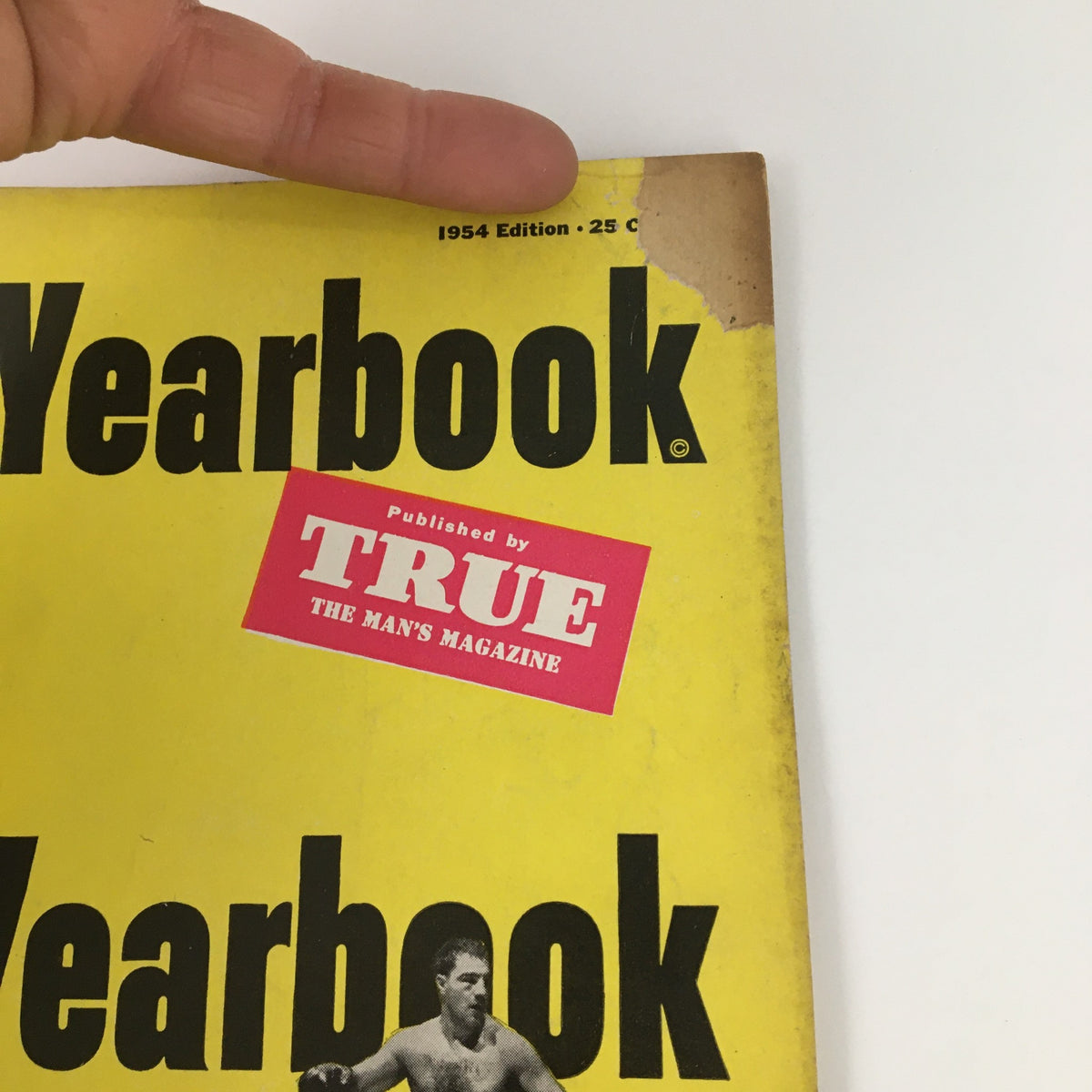 Cover of the 1954 TRUE The Man's Magazine Boxing Yearbook featuring prominent text and an image of a boxer. Published by TRUE, showcasing the title and year.