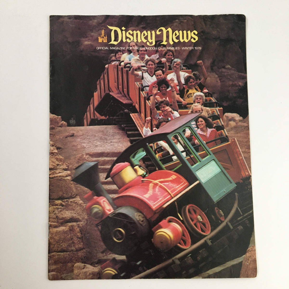 Cover of Disney News Magazine Winter 1979 featuring the Thunder Mountain Railroad. The image depicts happy riders on the coaster, capturing the excitement of the iconic Disney attraction.