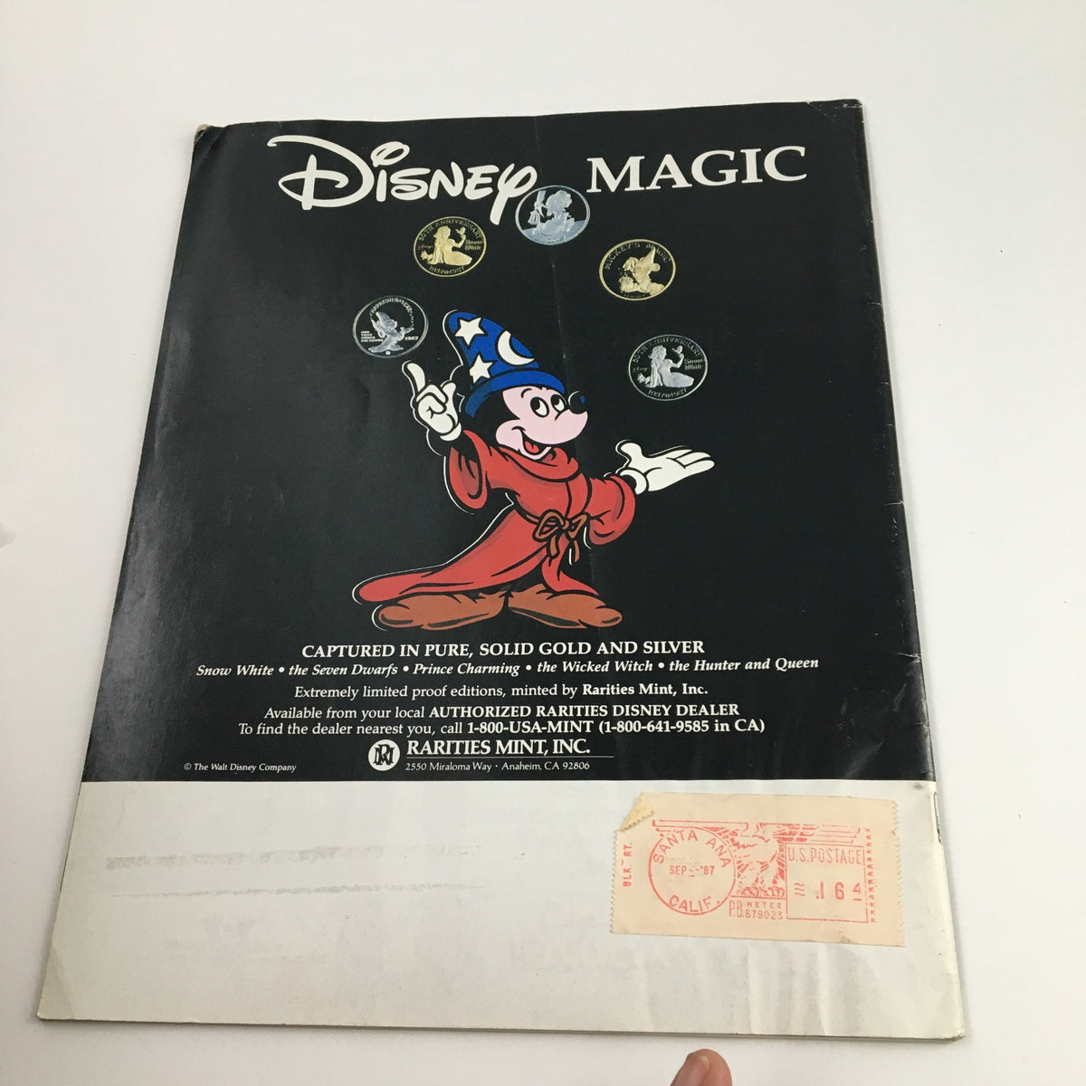 Back cover of Disney News Magazine Fall 1987 showcasing Disney Magic, with an illustration of Mickey Mouse and information about collectible coins.