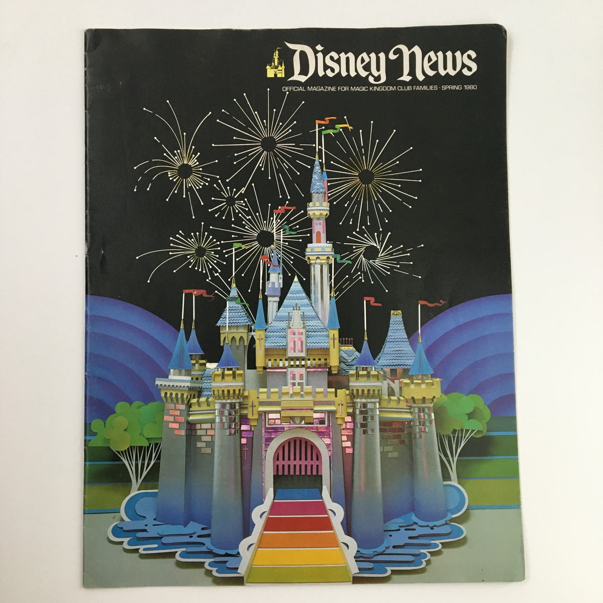 Disney News Magazine Spring 1980 cover featuring a colorful illustration of a castle with fireworks, highlighting the new film release of 'A Watcher in the Woods'.