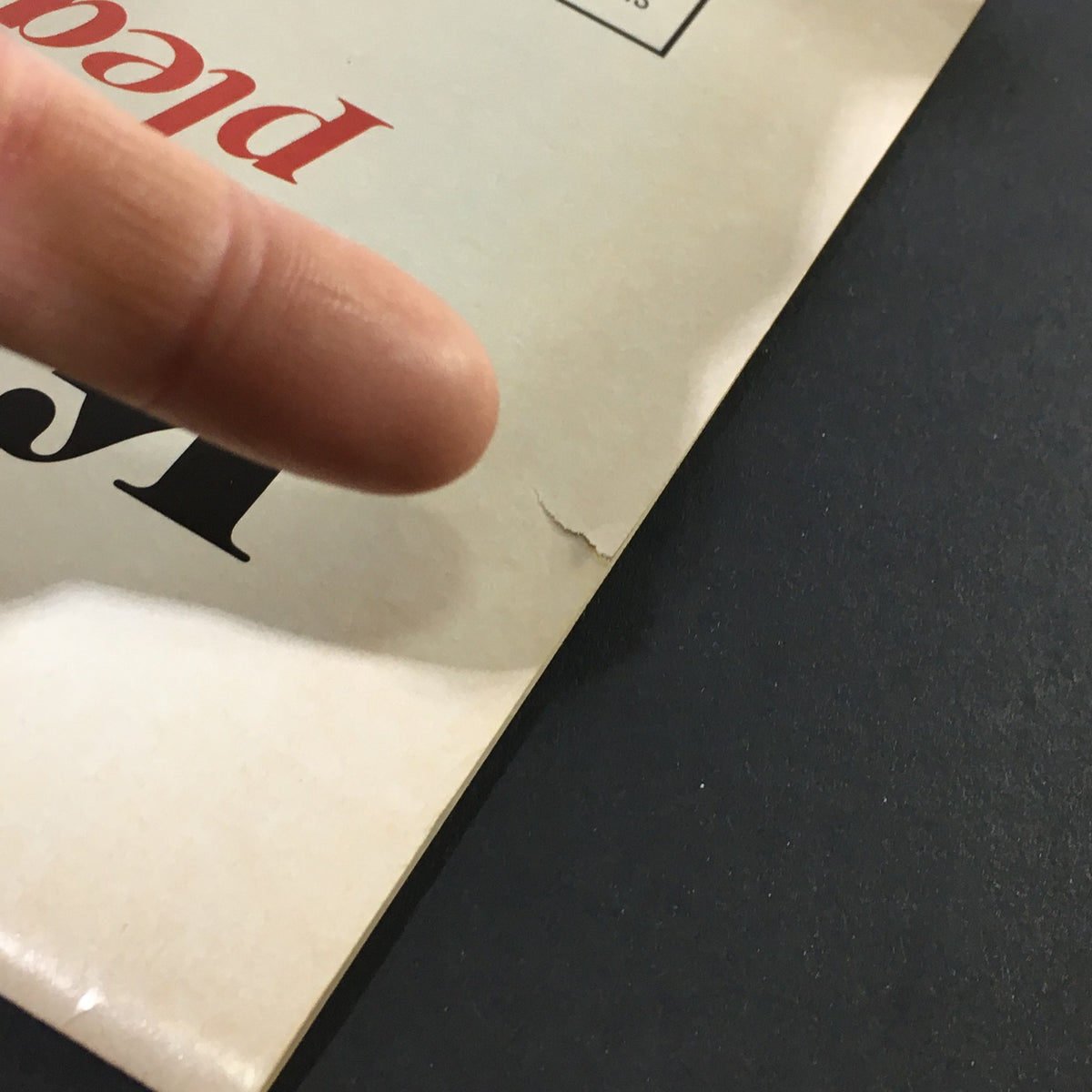 Close-up view of the back cover of the stagebill for Cats by Andrew Webber at the VTG Shubert Theatre, November 1985, highlighting slight wear with a visible small rip along the edge.