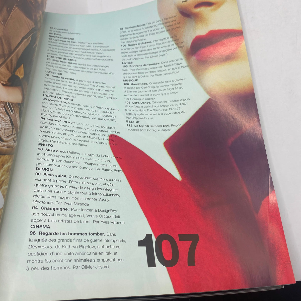 Page from Numéro Magazine October 2009 No. 107 featuring article listings and promotional content with a bold red accent.