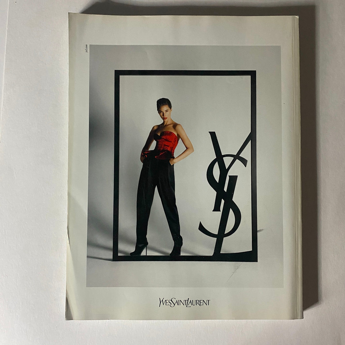 Cover of Numéro Magazine October 2009 No. 107 featuring a model in high fashion Yves Saint Laurent ensemble, framed with the iconic YSL logo.