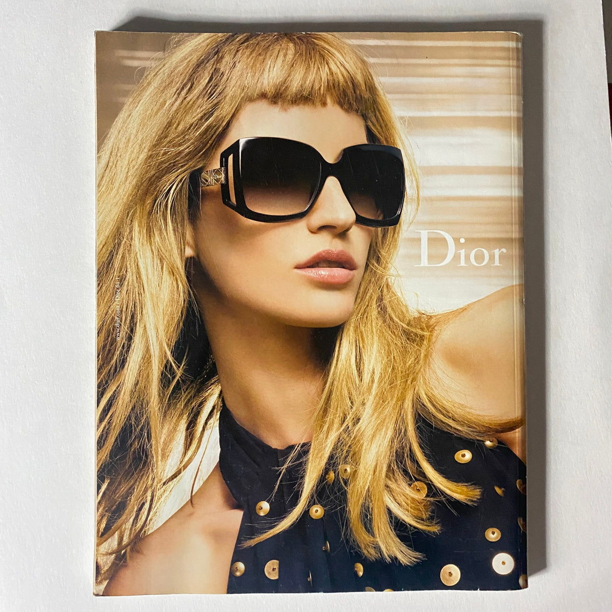Cover of a Dior advertisement featuring a beautiful model wearing sunglasses, illustrating the connection between fashion and luxury in Numéro Magazine April 2009 No. 102.