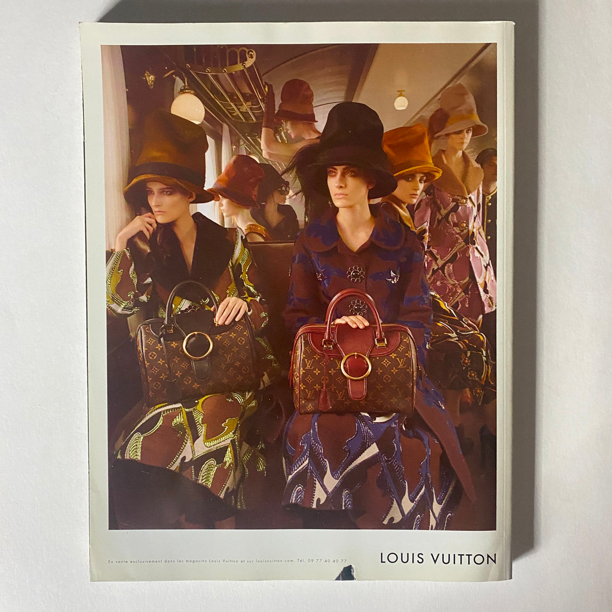 Fashion spread from Numéro Magazine October 2012 No. 137 showcasing a stylish collection by Louis Vuitton with models dressed in vibrant attire and unique hats.