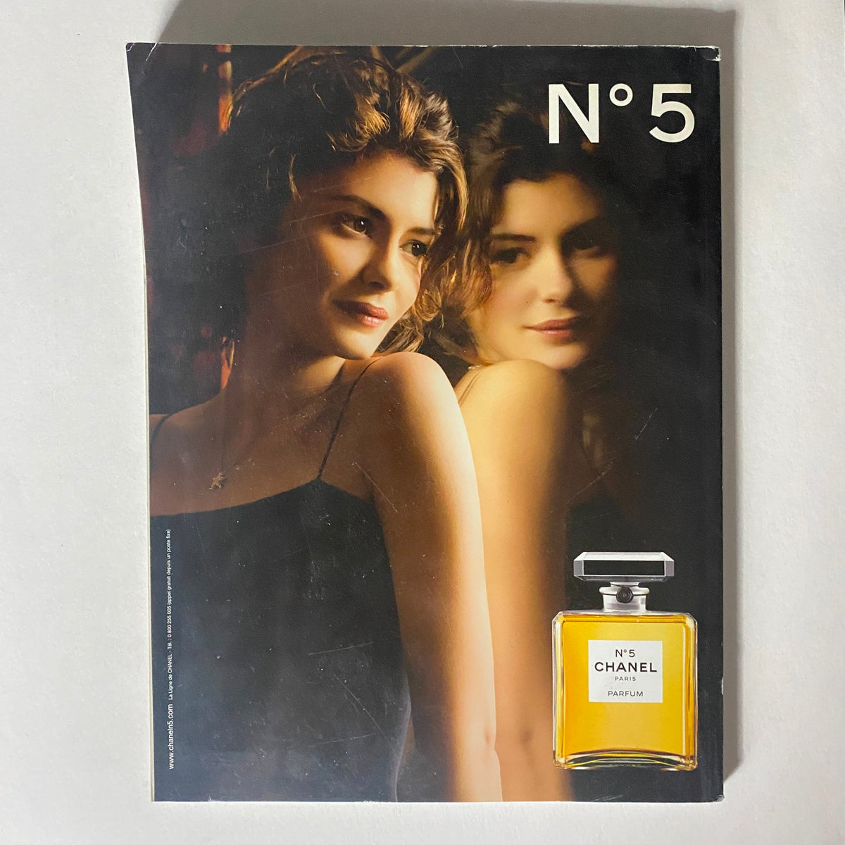 Cover of Numéro Magazine December 2009 No. 109 featuring a model with long hair posing alongside the Chanel N°5 perfume advertisement, emphasizing elegance and beauty.