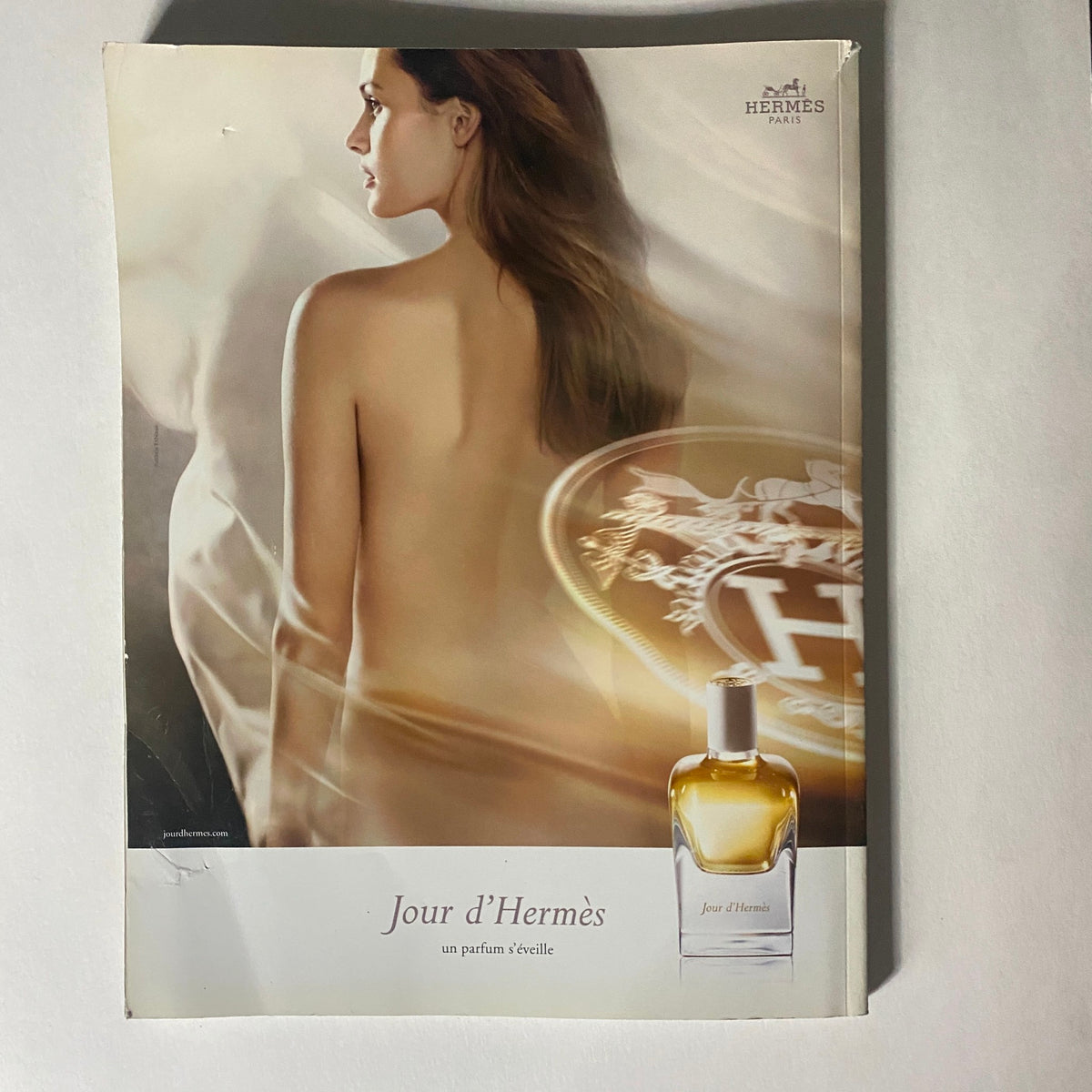 Perfume advertisement for Jour d'Hermès in Numéro Magazine June 2013 No. 144, featuring a model's back and the product.