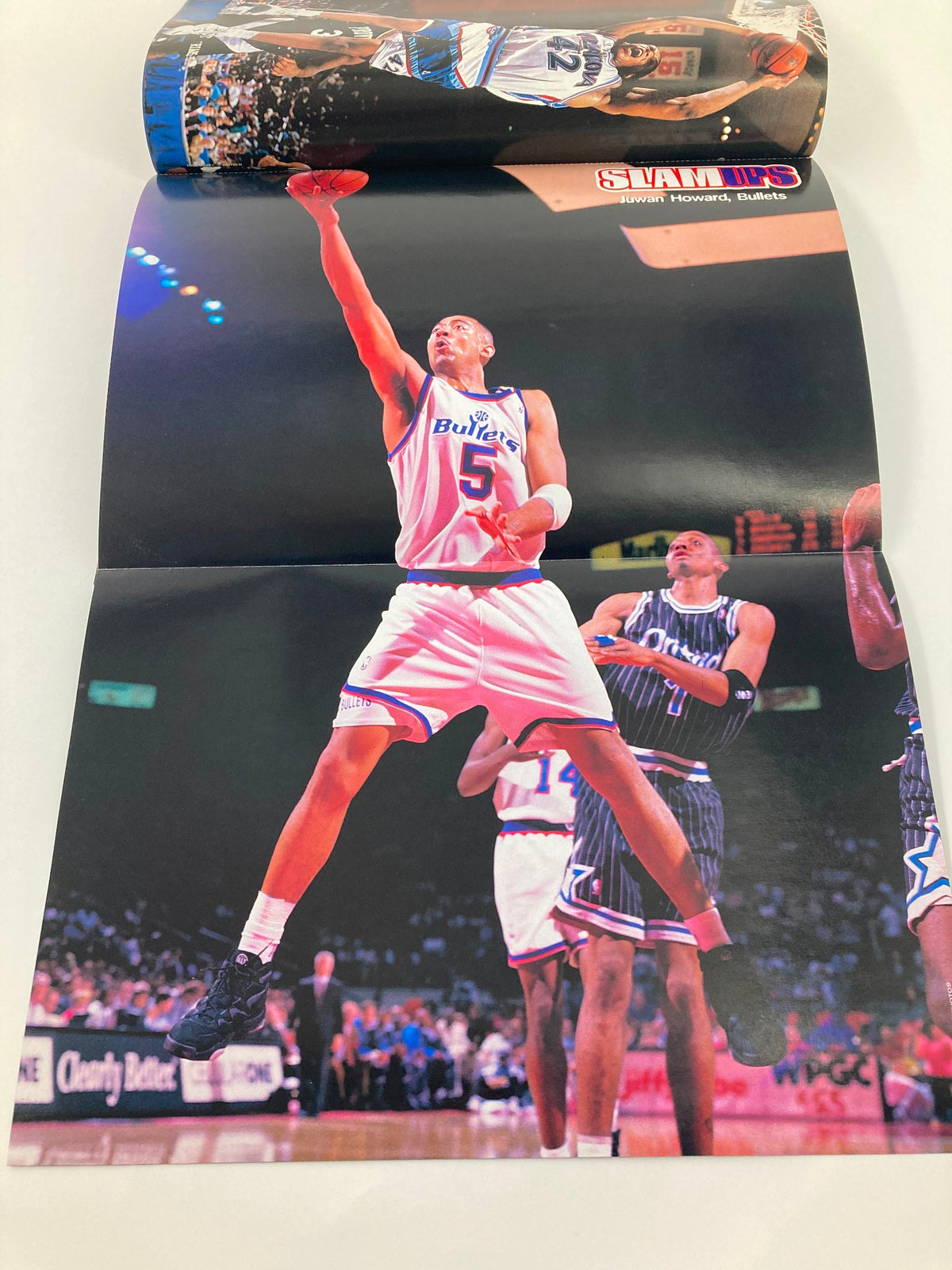 Poster from Slam Magazine December 1996 showcasing Juwan Howard from the Washington Bullets, capturing his athleticism during a dynamic play.