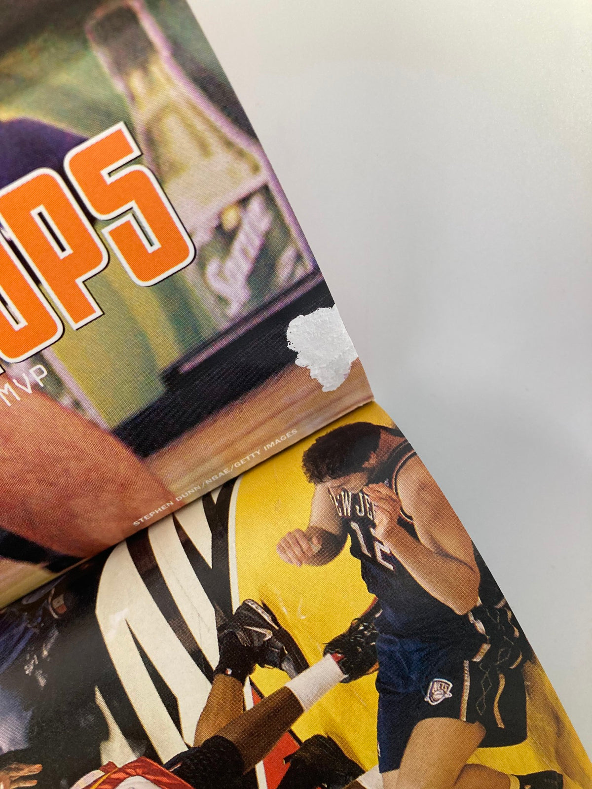Close-up of an image from Slam Magazine showing players engaged in a dynamic moment, highlighting the competitive spirit, from the August 2005 issue featuring Ron Artest.
