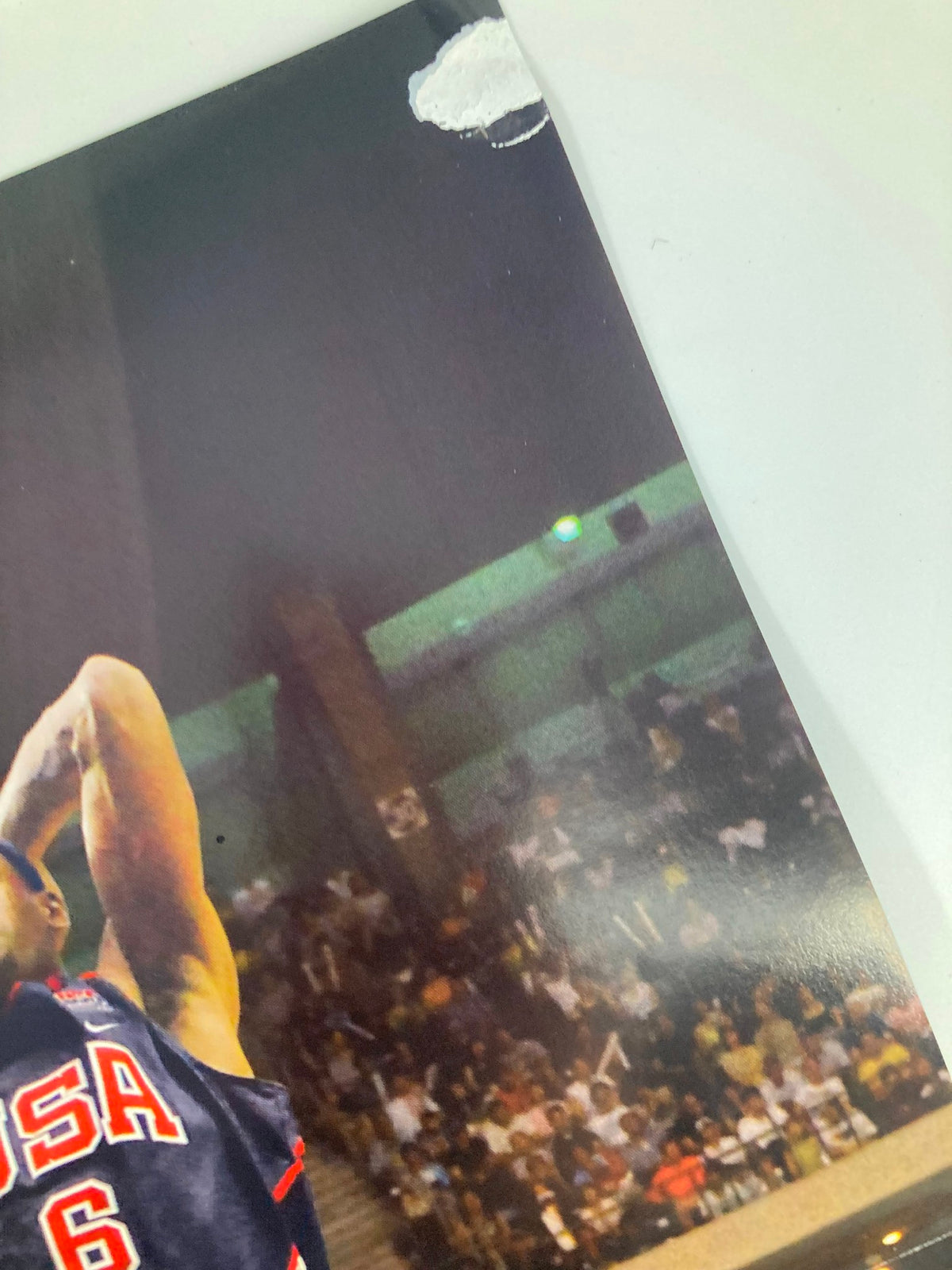 Detailed view of the Slam Magazine November 2006 poster featuring LeBron James in Team USA gear, emphasizing his athletic form while shooting during a basketball match.