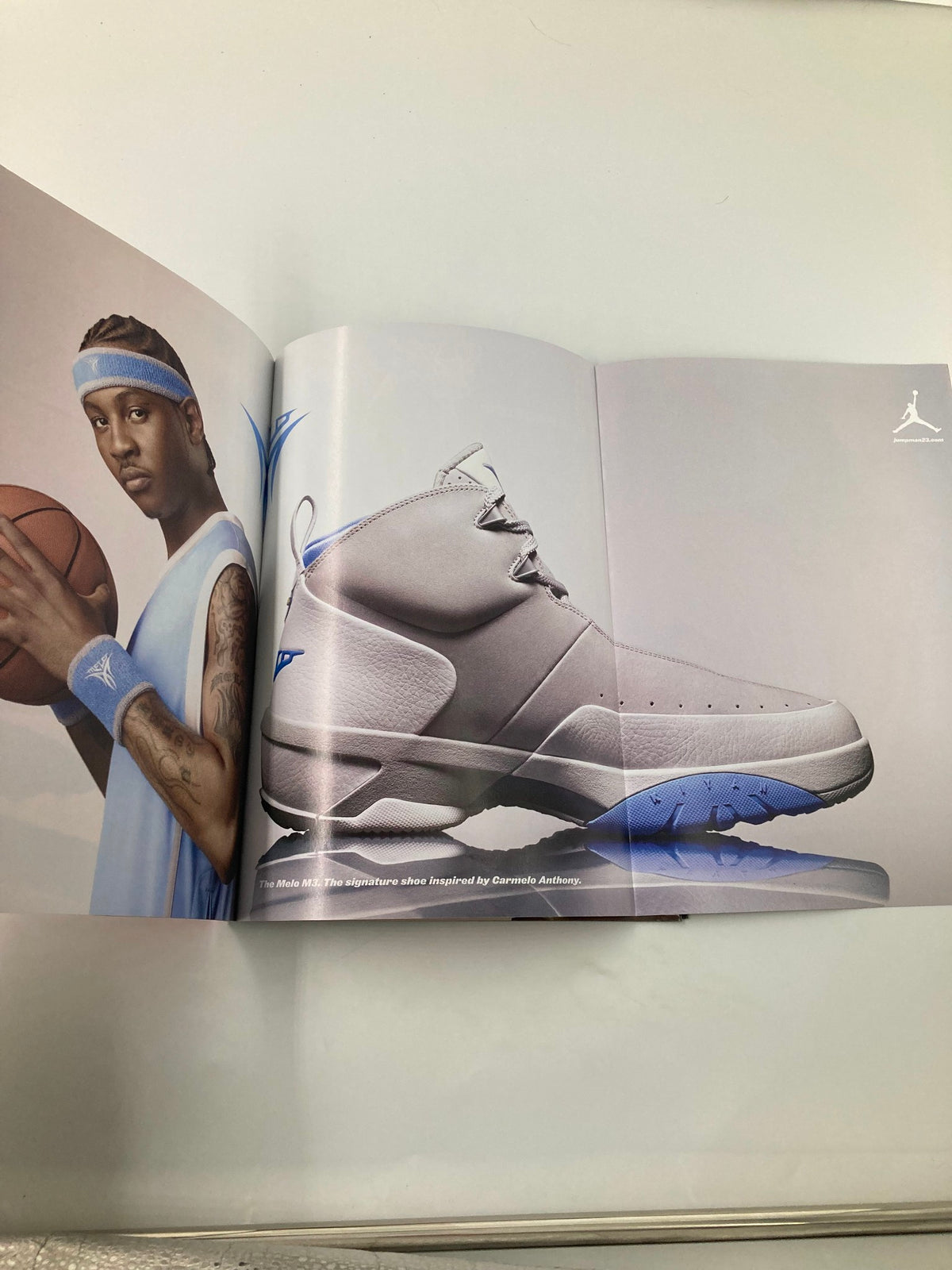 Slam Magazine December 2006 showcasing a stylish pair of basketball shoes alongside a model holding a basketball, highlighting the latest sneaker trends in the world of basketball memorabilia.